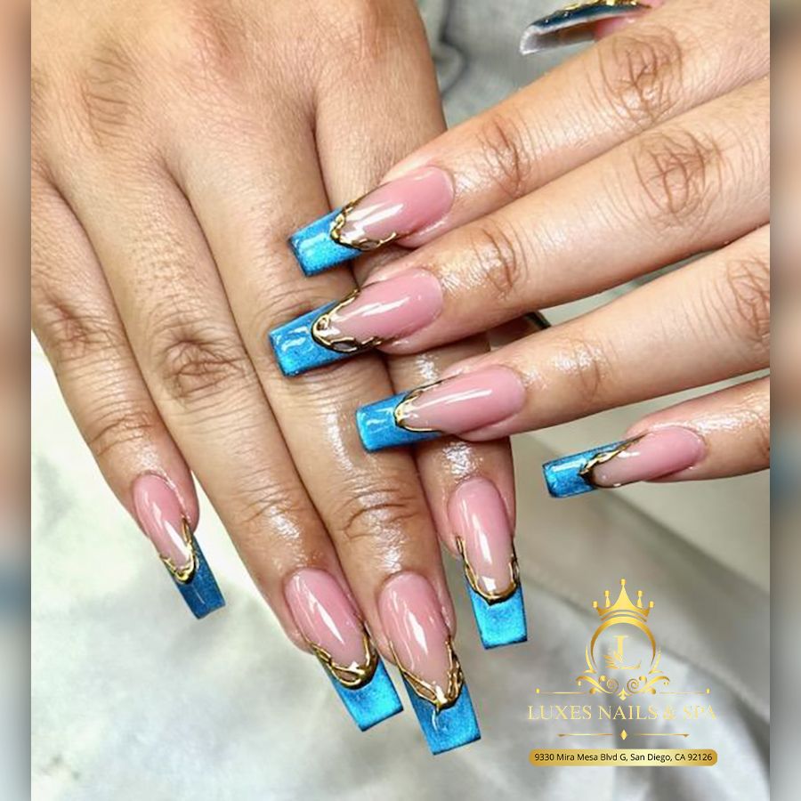 Blue French nail art with gold accents